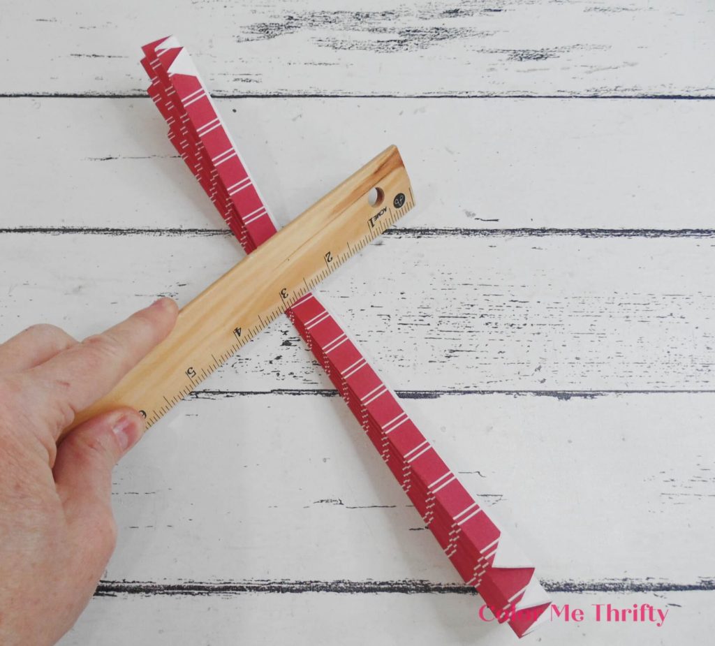 pressing on accordion folds with ruler
