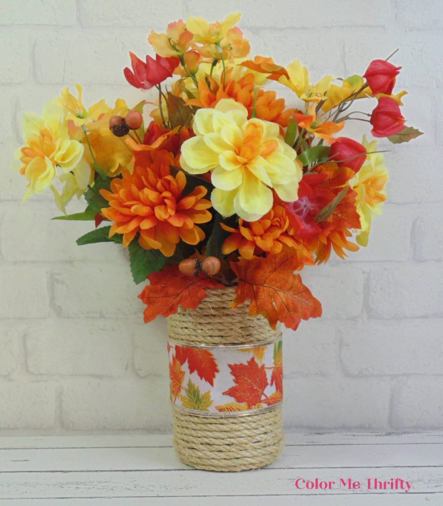 adding fall flowers to upcycled sisal rope vase