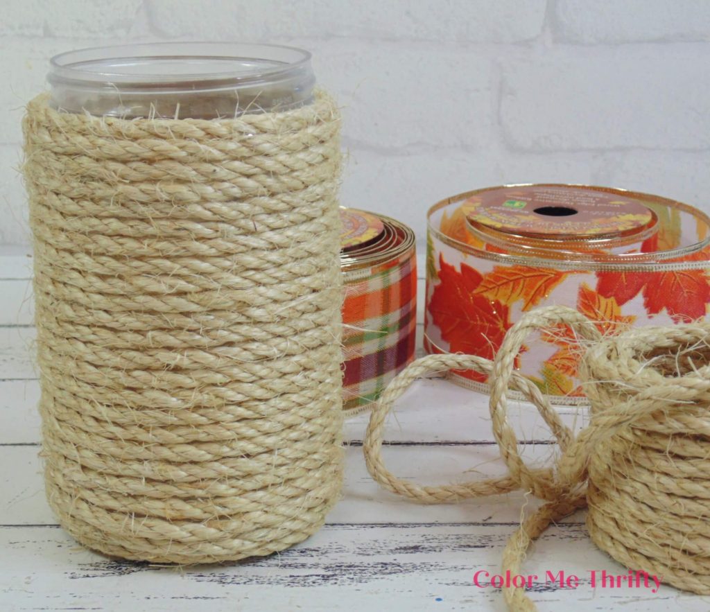 almost finished gluing sisal rope around peanut butter jar