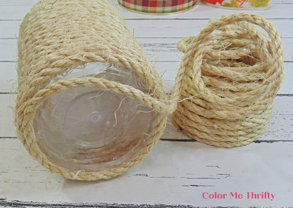 gluing sisal rope around bottom of peanut butter jar